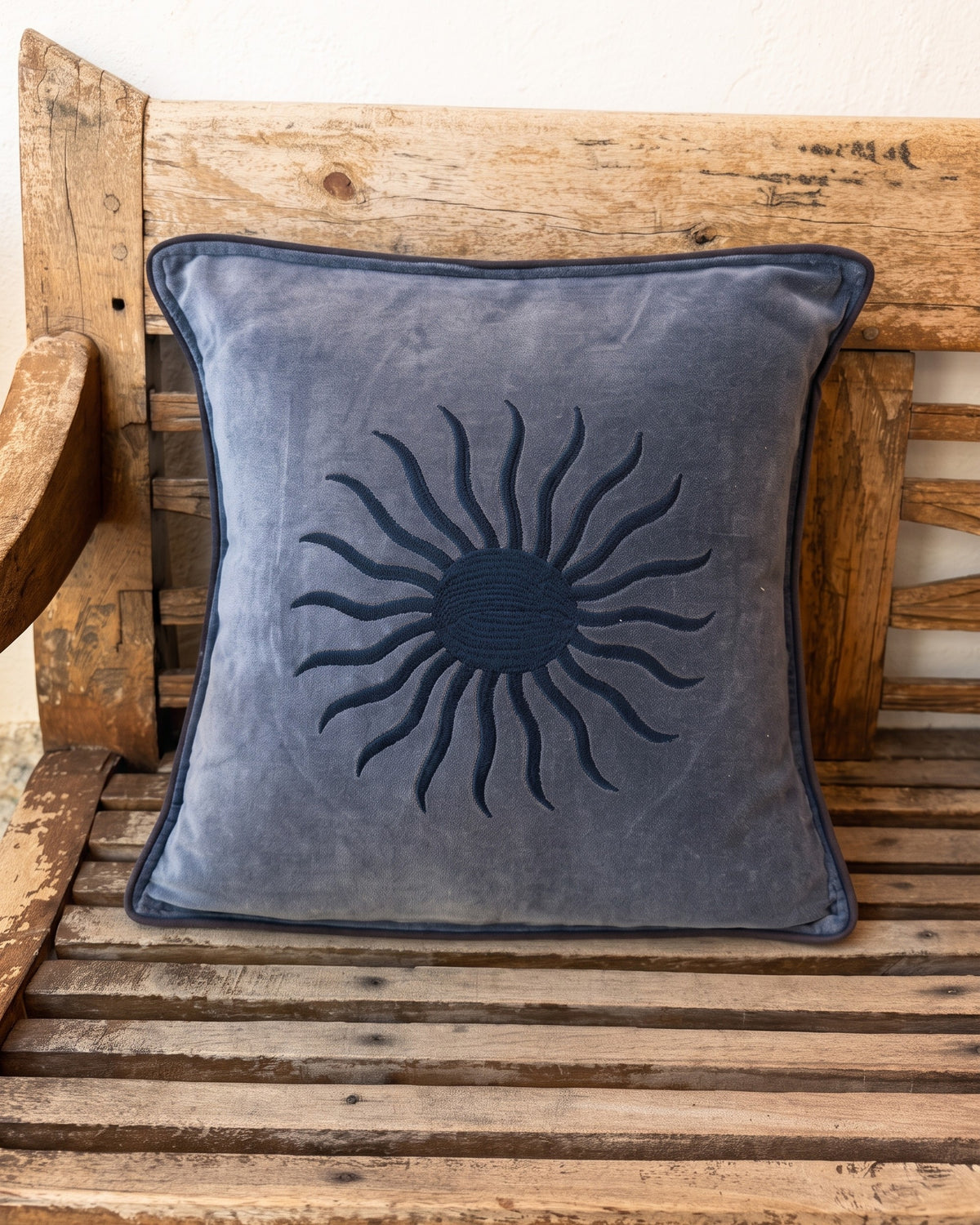 Soleil Cushion Blue and Navy on a wooden bench in Ibiza — La Fleury
