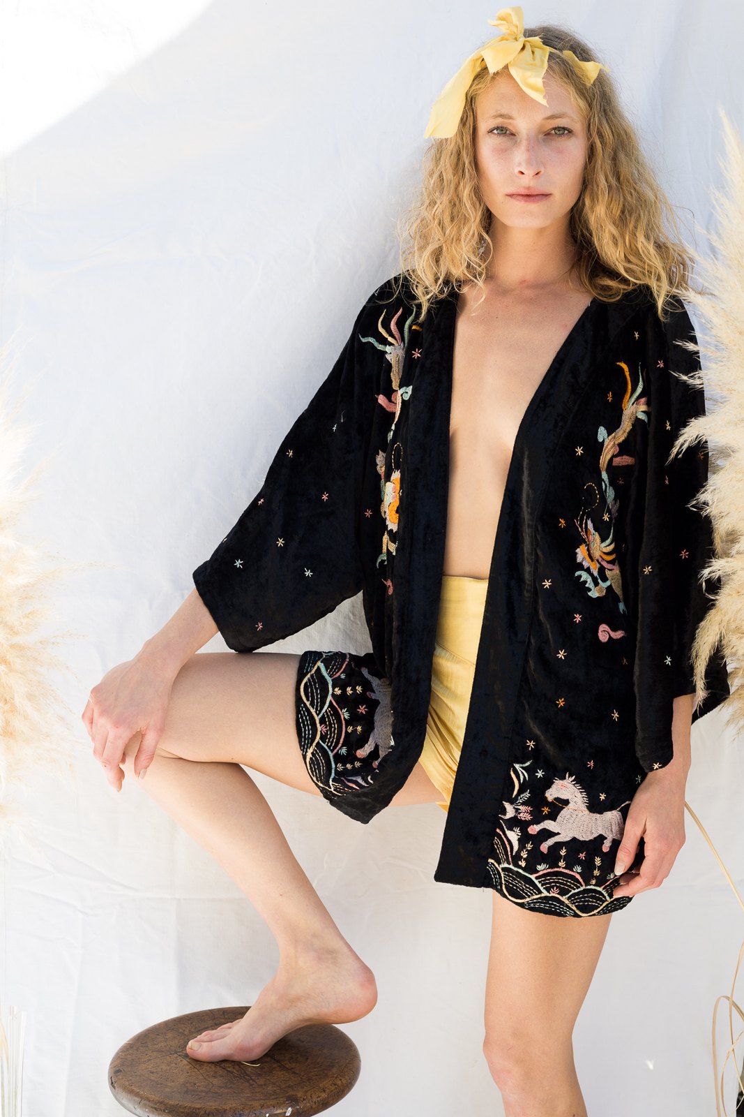 Model wearing the Dragon Kimono, hand embroidered on black velvet